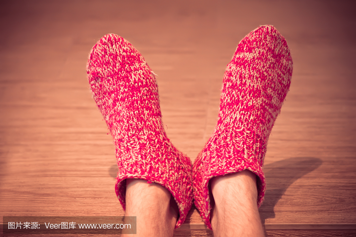 一个男人的脚穿着编织的红色袜子的特写
